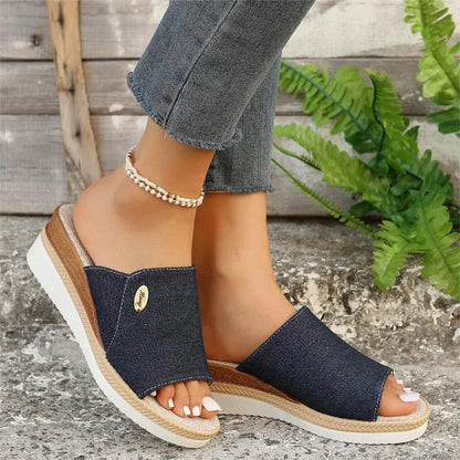 Model met Talia ergonomische sandalen in wit, zittend op een bankje.